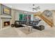 Inviting living room with a fireplace, leather sectional, and staircase leading to the upper level at 213 N Monterey Isle, Longwood, FL 32779