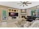 Cozy living room featuring built-in shelving, a fireplace, and comfortable seating for relaxing and entertaining at 213 N Monterey Isle, Longwood, FL 32779