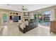 Bright living room with a view of the pool, comfortable seating, and a built-in entertainment center at 213 N Monterey Isle, Longwood, FL 32779