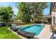 Swimming pool with lawn chairs, covered patio and waterfront view of a canal with boat docks at 213 N Monterey Isle, Longwood, FL 32779
