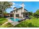 Backyard pool area featuring a covered patio and well-manicured lawn at 213 N Monterey Isle, Longwood, FL 32779