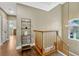 Wooden staircase leads to the second floor, with a decorative shelf and pendant light at 213 N Monterey Isle, Longwood, FL 32779