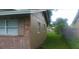 A view of the side of the house showcases the fenced backyard, with plenty of room for outdoor activities at 2260 Willie Mays Pkwy, Orlando, FL 32811