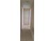 An interior hallway, features neutral walls, and tile flooring, connecting the living spaces of the home at 2260 Willie Mays Pkwy, Orlando, FL 32811