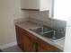 A clean kitchen area features a stainless steel sink and a practical layout, ready for home-cooked meals at 2260 Willie Mays Pkwy, Orlando, FL 32811