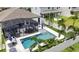 Aerial view of a private pool and screened enclosure in a residential backyard with palm trees at 2390 Standing Rock Cir, Oakland, FL 34787