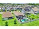 Aerial view of a home with a screened pool, patio, backyard, and manicured lawn at 2390 Standing Rock Cir, Oakland, FL 34787