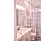 Bright bathroom with patterned shower curtain, white vanity and coordinated décor at 2390 Standing Rock Cir, Oakland, FL 34787