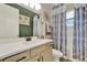 Bathroom featuring a vanity with drawers, mirror, and shower/tub combo with patterned curtains at 2390 Standing Rock Cir, Oakland, FL 34787