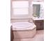 Bright bathroom featuring a soaking tub with tile surround and window with blinds at 2390 Standing Rock Cir, Oakland, FL 34787