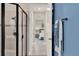 Modern bathroom featuring a glass-enclosed shower with neutral tile and a serene doorway view at 2390 Standing Rock Cir, Oakland, FL 34787