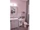 Bathroom with a light-grey vanity, patterned mirror, and a nearby toilet at 2390 Standing Rock Cir, Oakland, FL 34787