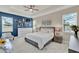 Bright bedroom showcasing a comfortable bed, modern ceiling fan, and natural light streaming through the windows at 2390 Standing Rock Cir, Oakland, FL 34787