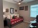 Cozy bedroom featuring a daybed with sports memorabilia and a ceiling fan at 2390 Standing Rock Cir, Oakland, FL 34787