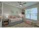 Charming bedroom with neutral walls, plush carpet, ceiling fan, and an abundance of natural light at 2390 Standing Rock Cir, Oakland, FL 34787