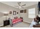 A cozy bedroom featuring Alabama sports decor, a comfortable daybed, and a ceiling fan at 2390 Standing Rock Cir, Oakland, FL 34787