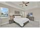 Spacious bedroom boasts tray ceilings, large windows, and contemporary furnishings for a serene retreat at 2390 Standing Rock Cir, Oakland, FL 34787