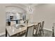 Modern dining room with views into the kitchen, a stylish light fixture, and seating for comfortable entertaining at 2390 Standing Rock Cir, Oakland, FL 34787