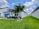 Well-manicured lawn and tropical landscaping accentuate the exterior of this charming single Gathering home at 2390 Standing Rock Cir, Oakland, FL 34787