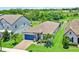 Charming single-story home featuring a well-manicured lawn, lush landscaping, and a brick-paved driveway at 2390 Standing Rock Cir, Oakland, FL 34787
