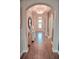 Inviting hallway with arched doorways and neutral tones leads to the home's interior at 2390 Standing Rock Cir, Oakland, FL 34787