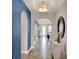 Elegant hallway with archways leading to various living spaces, enhanced by stylish decor and neutral color palette at 2390 Standing Rock Cir, Oakland, FL 34787