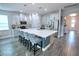 Modern kitchen with white cabinetry, stainless steel appliances, and a large center island with seating at 2390 Standing Rock Cir, Oakland, FL 34787