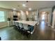 Bright kitchen features a large island, stainless appliances, and modern pendant lighting at 2390 Standing Rock Cir, Oakland, FL 34787