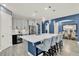 Modern kitchen featuring a spacious island, bar stool seating, and open concept design at 2390 Standing Rock Cir, Oakland, FL 34787