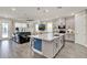 Open-concept kitchen with a large island, stainless steel appliances, and a seamless flow into the living area at 2390 Standing Rock Cir, Oakland, FL 34787