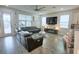 Spacious living room with hardwood floors, plush seating, a large TV, and plenty of natural light at 2390 Standing Rock Cir, Oakland, FL 34787