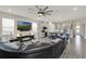 Spacious living area featuring a modern kitchen, cozy seating, and seamless connectivity for entertaining and relaxation at 2390 Standing Rock Cir, Oakland, FL 34787