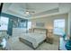 Spacious bedroom features tray ceiling, ample natural light, and modern decor at 2390 Standing Rock Cir, Oakland, FL 34787