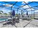 Relaxing outdoor seating area with full screened enclosure and charming patio lighting at 2390 Standing Rock Cir, Oakland, FL 34787