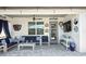 Relaxing covered patio with comfortable seating, ceiling fan, and mounted TV at 2390 Standing Rock Cir, Oakland, FL 34787