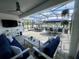 Covered lanai featuring comfortable seating, an outdoor kitchen, and a dining area at 2390 Standing Rock Cir, Oakland, FL 34787