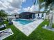 Stunning pool area with screened enclosure, lush landscaping, and plenty of space for outdoor entertaining at 2390 Standing Rock Cir, Oakland, FL 34787