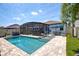 Inviting pool area featuring a screened enclosure, patio seating, and a well-manicured lawn at 2390 Standing Rock Cir, Oakland, FL 34787