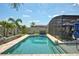 Beautiful in-ground pool with a screened enclosure, perfect for outdoor enjoyment and relaxation at 2390 Standing Rock Cir, Oakland, FL 34787