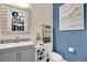 Stylish powder room with contemporary vanity, mirror and decor, combining elegance and functionality at 2390 Standing Rock Cir, Oakland, FL 34787