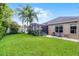 Expansive backyard with a screened patio, lush greenery, and well-maintained lawn, ideal for outdoor activities and relaxation at 2418 Ridgemooor Dr, Orlando, FL 32828