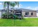Expansive backyard showcases a screened lanai, lush landscaping, a well-maintained lawn and serene outdoor living space at 2418 Ridgemooor Dr, Orlando, FL 32828