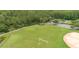 Community baseball field with lush grass and mature trees surrounding it at 2418 Ridgemooor Dr, Orlando, FL 32828