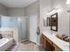 Bright bathroom features a double sink vanity, bathtub, and a separate glass-enclosed shower at 2418 Ridgemooor Dr, Orlando, FL 32828