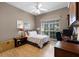 Comfortable bedroom features a light-filled window, laminate floors and matching side tables at 2418 Ridgemooor Dr, Orlando, FL 32828