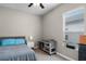 Cozy bedroom showcasing neutral walls, plush carpet, a bright window, and a ceiling fan at 2418 Ridgemooor Dr, Orlando, FL 32828