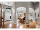 Inviting foyer with arched doorways leading to dining room and featuring gleaming hardwood floors and plenty of natural light at 2418 Ridgemooor Dr, Orlando, FL 32828