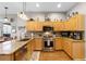 Well-equipped kitchen featuring granite counters, stainless steel appliances, wood floors, and an open design for entertaining at 2418 Ridgemooor Dr, Orlando, FL 32828