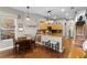 Open kitchen featuring wood floors, a center island with breakfast bar, modern light fixtures, and stainless steel appliances at 2418 Ridgemooor Dr, Orlando, FL 32828