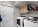 Functional laundry room with modern front-loading washer and dryer units at 2418 Ridgemooor Dr, Orlando, FL 32828